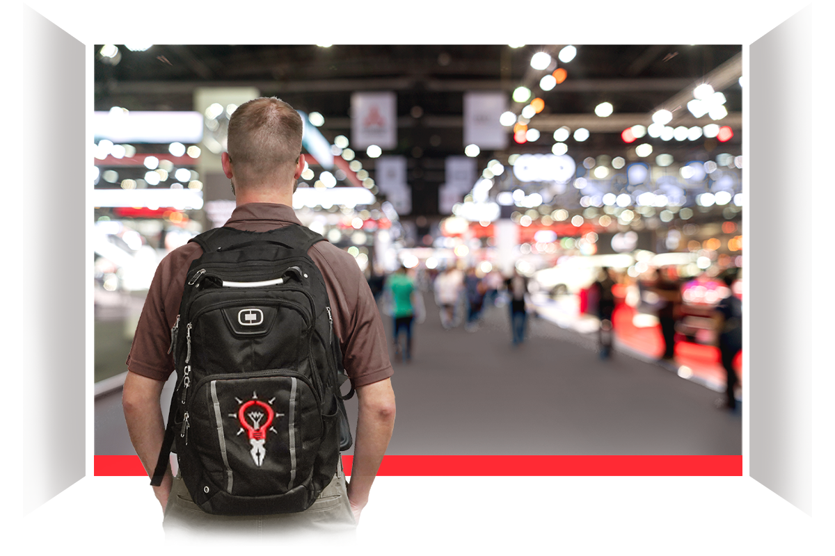 Guy with backpack looking over trade show crowd